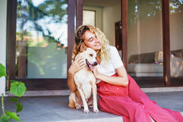 a young woman cuddles her emotional support dog